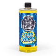 A bottle of Salty Captain Car Wash with a label featuring a cartoon character and a splash of blue and yellow colors.